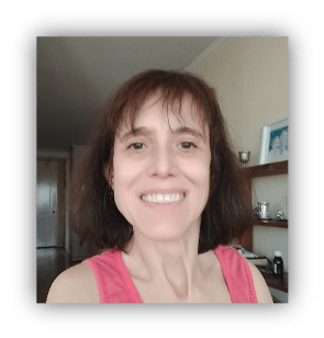 Karina smiles at the camera. She has shoulder length hair and is wearing a pink tank top.